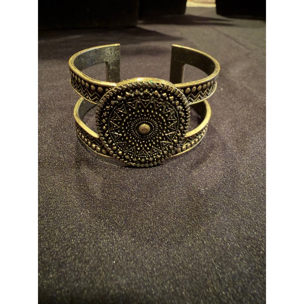 Antiqued brass style  bracelet with sunburst textures on a double-band cuff
